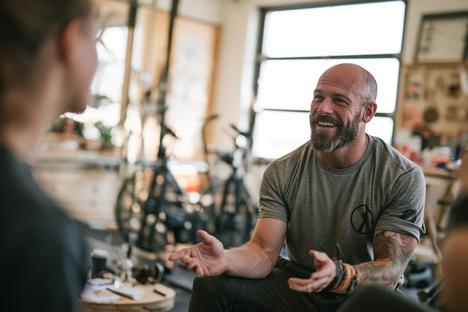 A personal trainer coaching a client in a warm, sunlit Berkeley studio